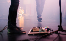 guitar pedals on stage at a concert