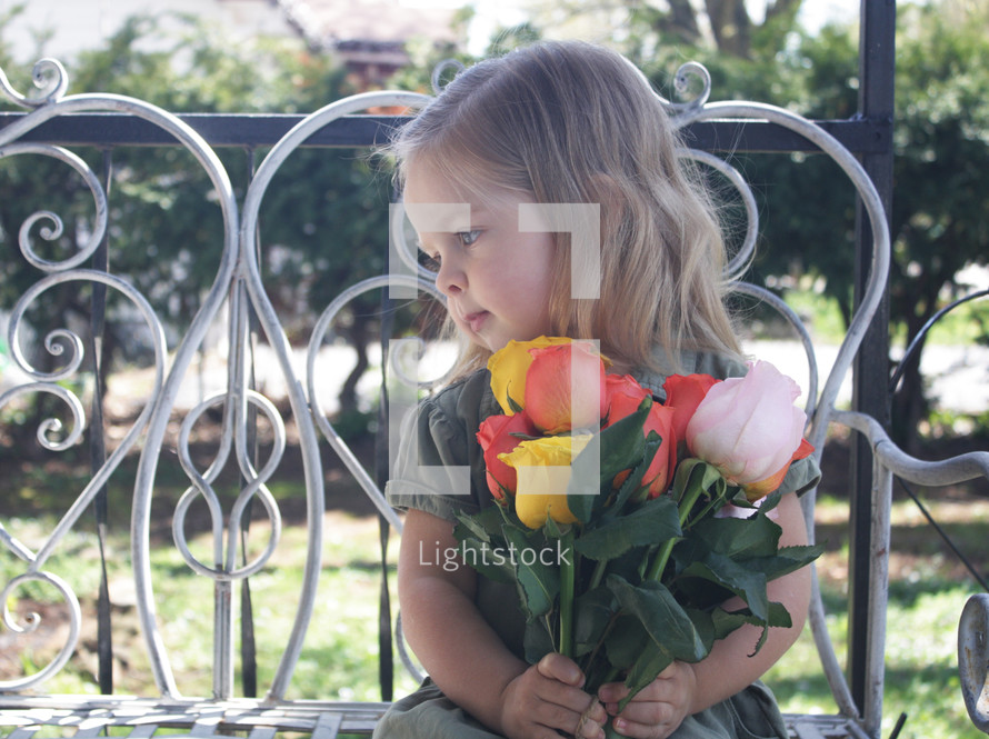 a child holding a bouquet of tulips 