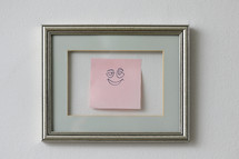 smiley face sticky note in a frame 