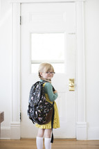 girl child standing at a door - first day of school 