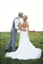 bride and groom kissing outdoors 