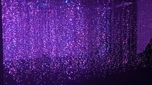 sparking curtain of lights and purple stage