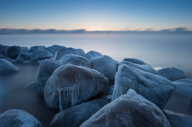 ice on stones along a shore 