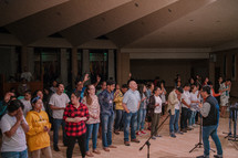 standing in song at a worship service 