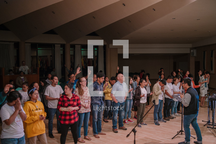standing in song at a worship service 