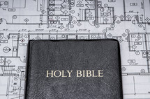 blueprints and a Bible 