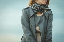 a woman in a scarf and blazer 