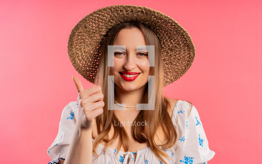 Stylish woman with hand sign like, thumbs up gesture. Happy lady, correct perfect choice, great deal, pink background. Positive female model smiles to camera, approval, trust concept. quality