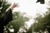 a girl tossing her cap at graduation 