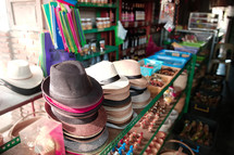 hats and trinkets for sale in a shop 