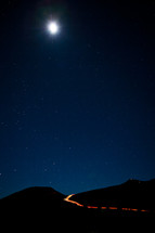 stars in the night sky over mountaintops
