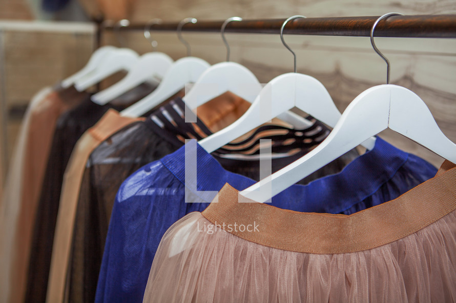 Skirts hang on hanger in fashion store