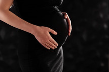 pregnant woman in a beautiful dress. Focus on the abdomen.