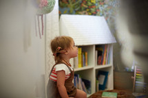 a toddler girl in a playroom 