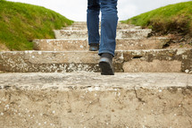 a man walking up concrete steps outdoors.