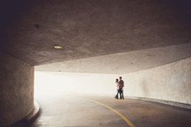 Couple hugging in a tunnel