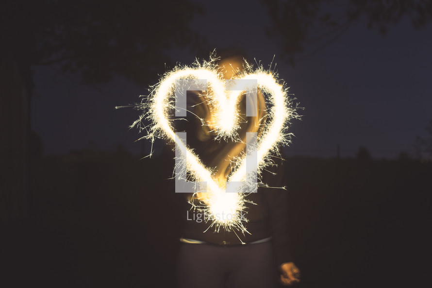 sparkler forming a heart at night.