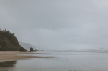 tide washing onto an overcast beach 
