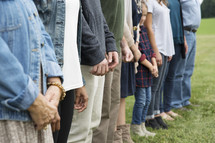family holding hands in a circle in prayer 
