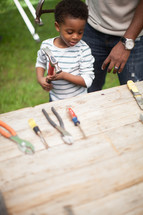 father and son using tools 