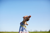 a girl dancing in a field 
