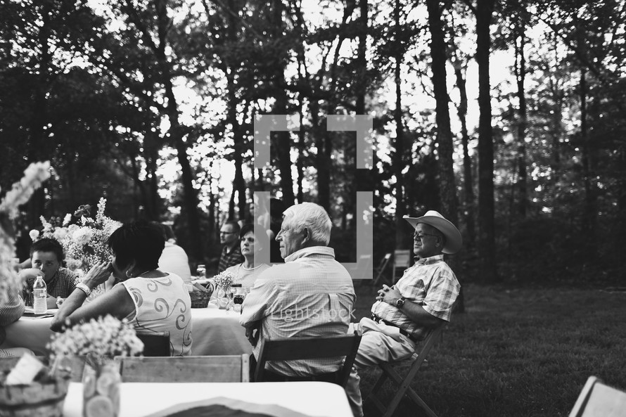 people sitting at an outdoor reception 