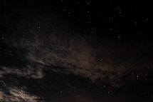 clouds and stars in the night sky 