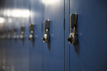 rows of blue lockers in a high school.