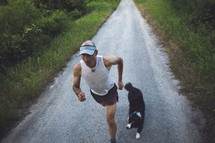 A man jogging with his dog. 