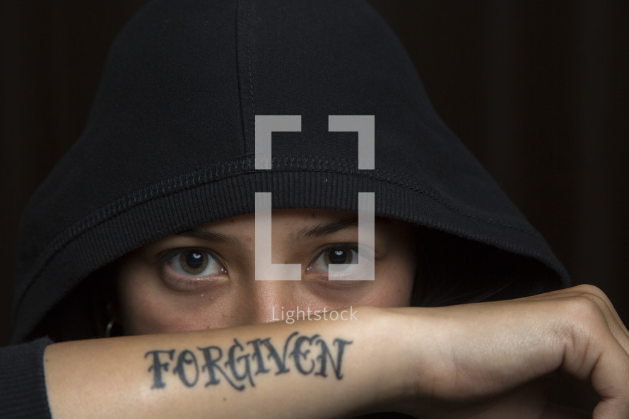 woman's eyes and a forgiven tattoo