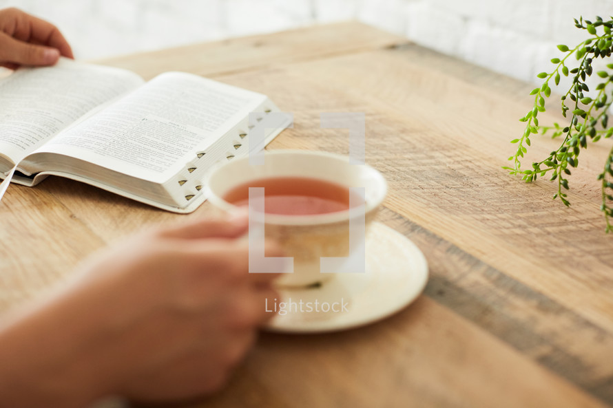 a woman with tea reading a Bible 