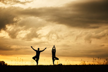 silhouettes of a couple stretching 