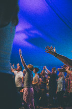 raised hands and praising God at a worship service 