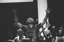 a man with raised hands in worship 