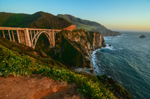 bridge over a ravine along a mountainous coastline 