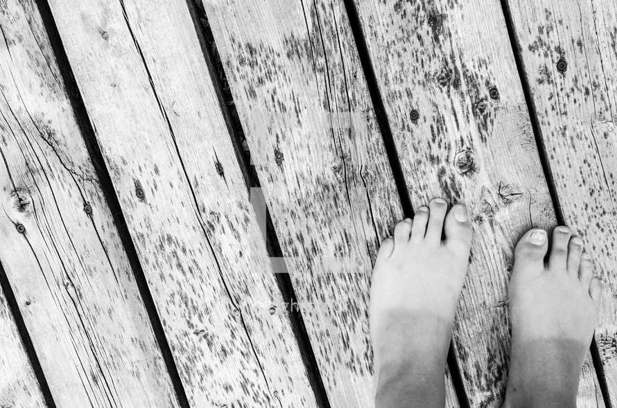 Feet on a wooden deck.