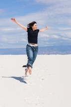 Woman Jumping and Feeling Free in the Desert