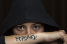 woman's eyes and a forgiven tattoo