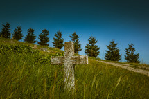 cross on a grassy hill 