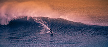 surfer braving a large wave