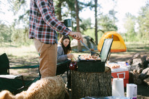 a man cooking breakfast while camping 
