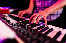 man playing a keyboard 