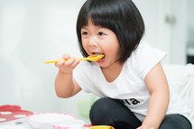 toddler girl eating food 