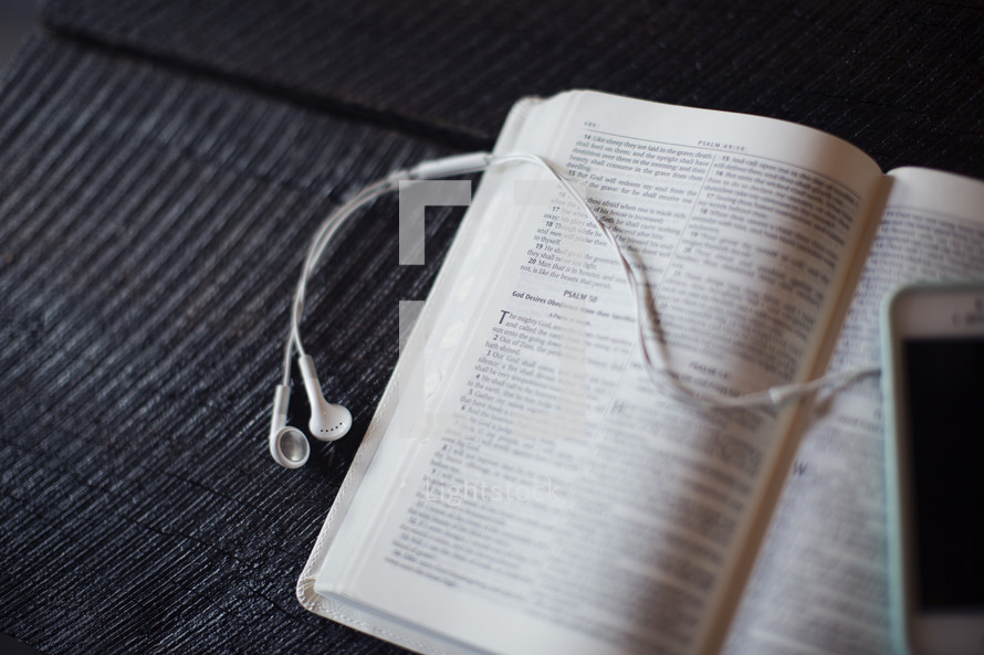 podcast, iPod and earbuds on open Bible 