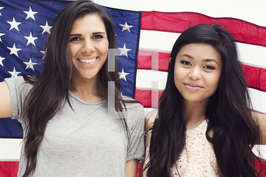 friendship between young women under an American Flag