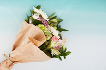 bouquet of flowers in brown paper 