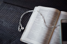 podcast, iPod and earbuds on open Bible 