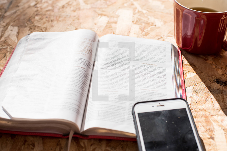 iPhone, opened Bible and coffee cup 