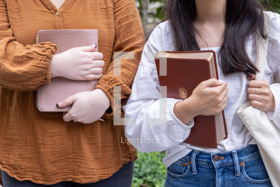 two women holding Bibles 