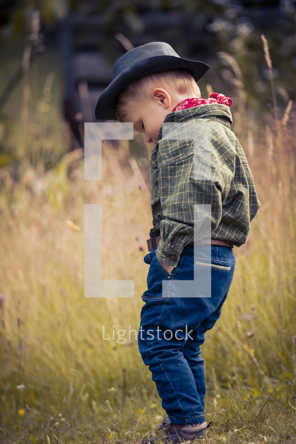 Little Cute Boy in Western Costume and Cowboy Hat